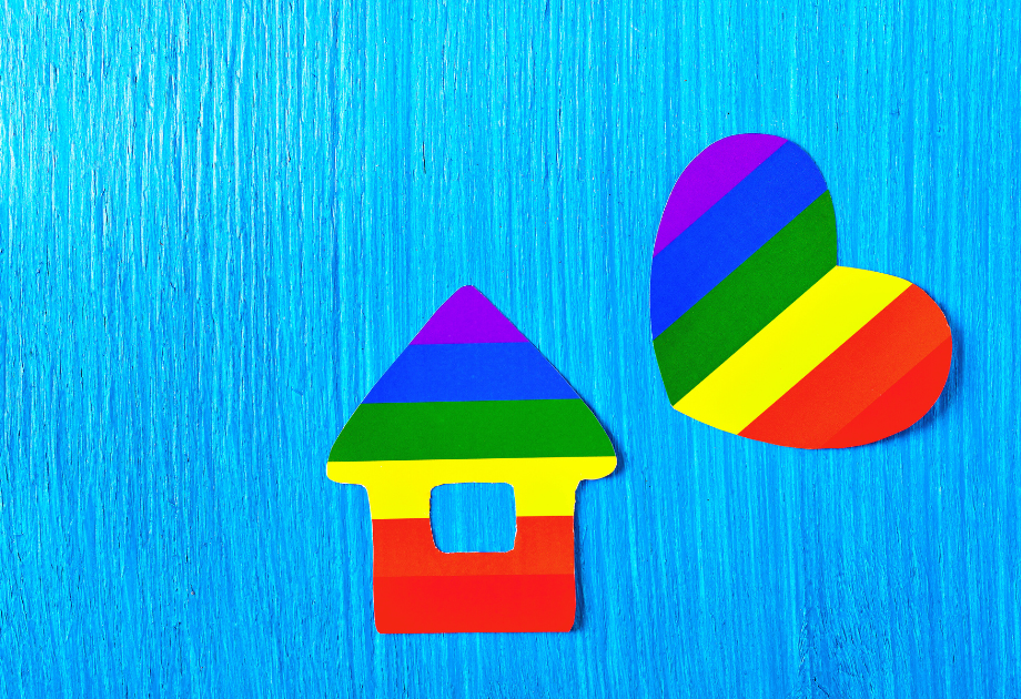 rainbow painted wooden cut outs of a house and a heart